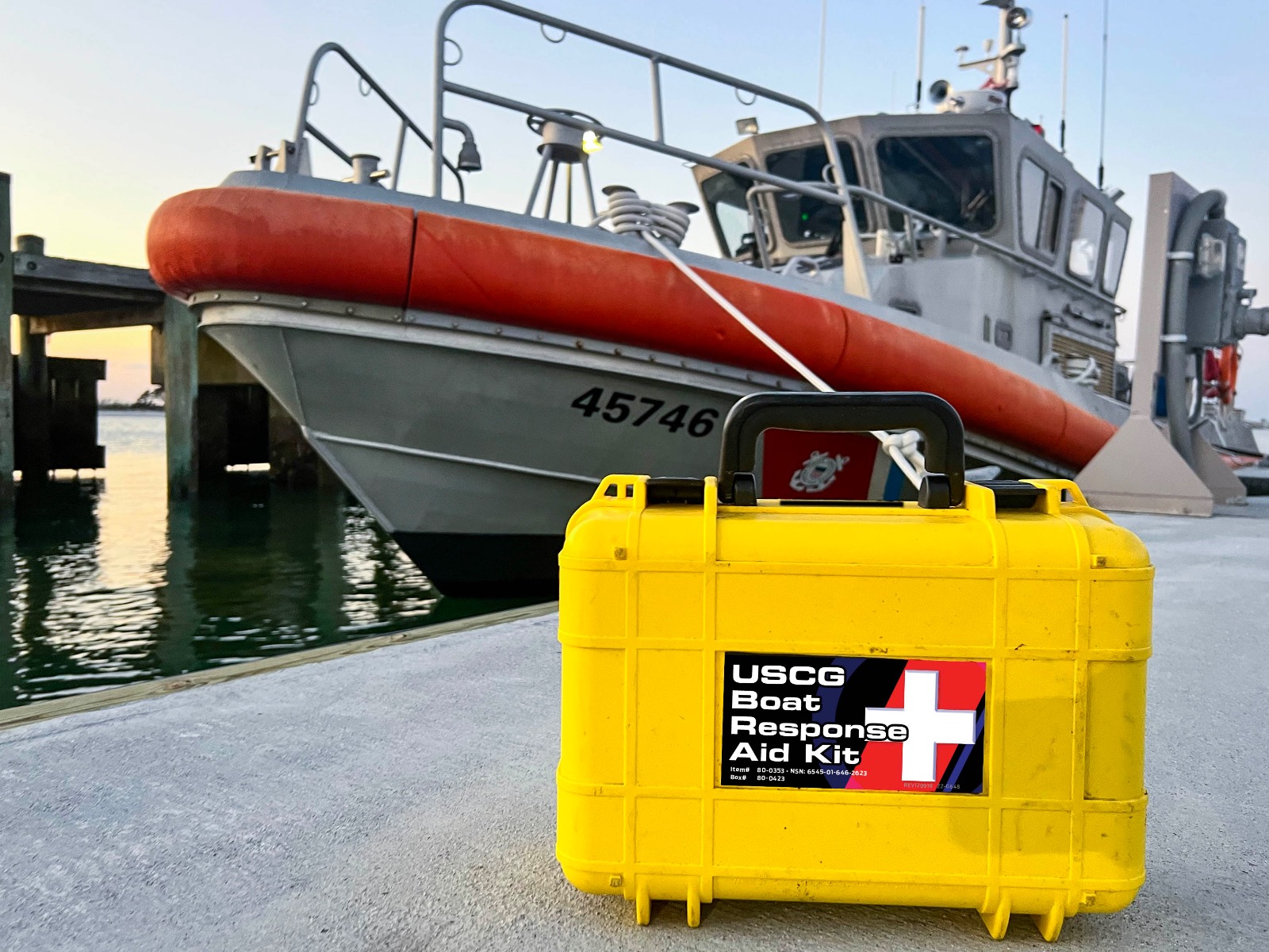 USCG Kit on dock with Coast Guard ship in background